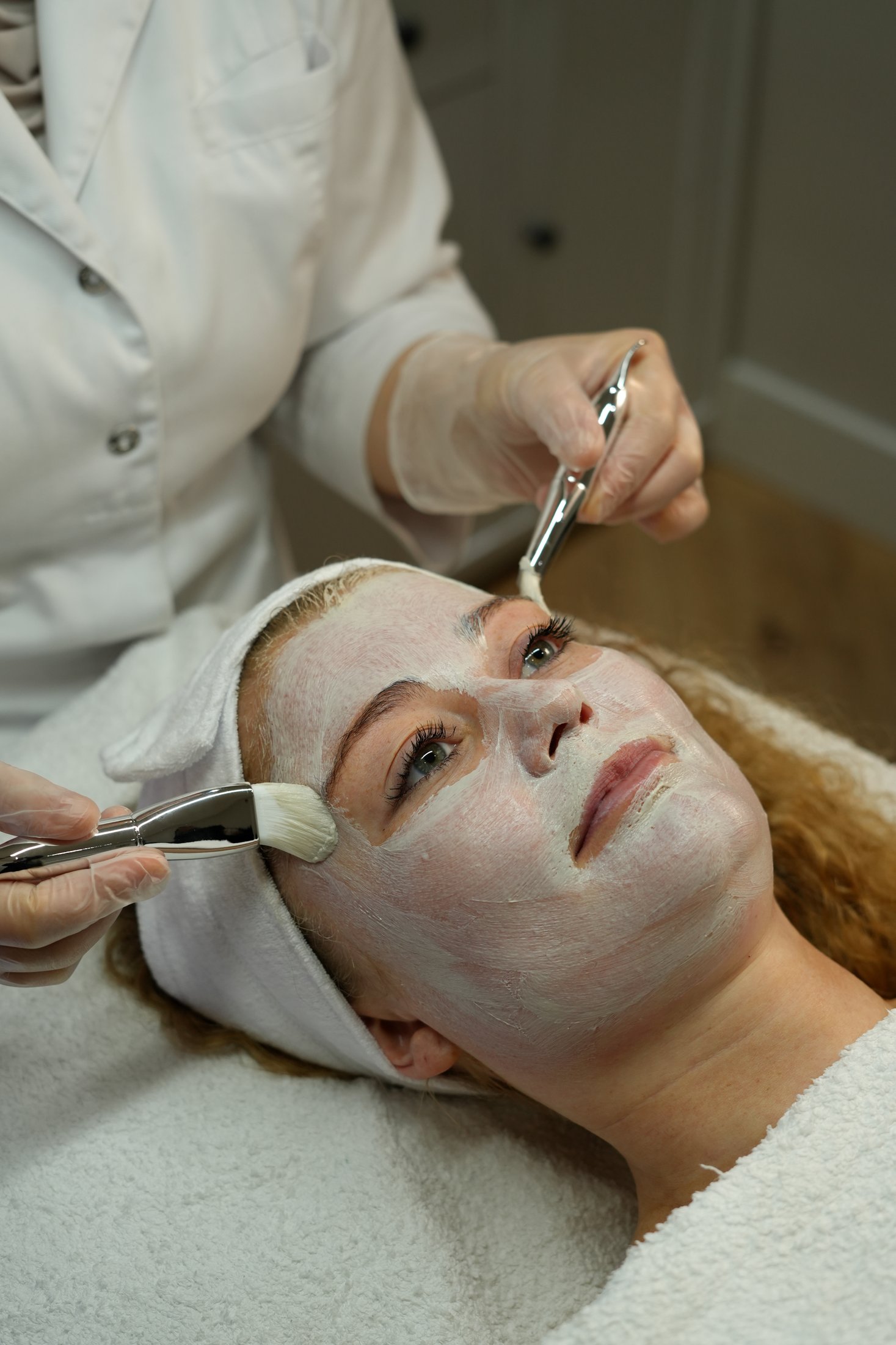 Een masker wordt aangebracht tijdens een gezichtsbehandeling